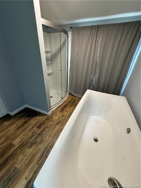 bathroom with hardwood / wood-style floors and walk in shower