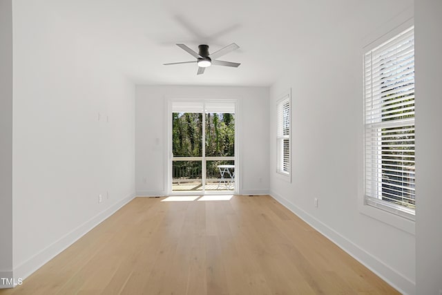 empty room with light wood-style floors, baseboards, and a ceiling fan