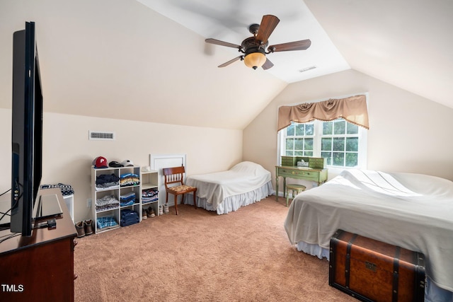 bedroom with carpet floors, visible vents, vaulted ceiling, and a ceiling fan