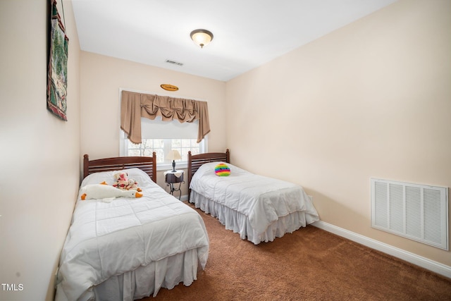 carpeted bedroom featuring baseboards and visible vents