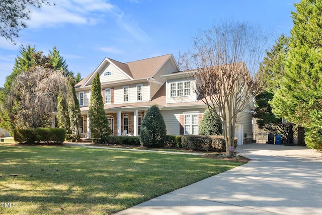 view of front of house with concrete driveway and a front yard