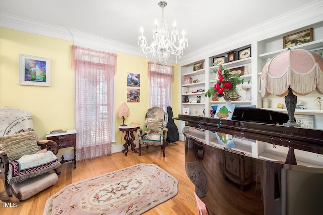 interior space featuring a notable chandelier, built in shelves, wood finished floors, and crown molding