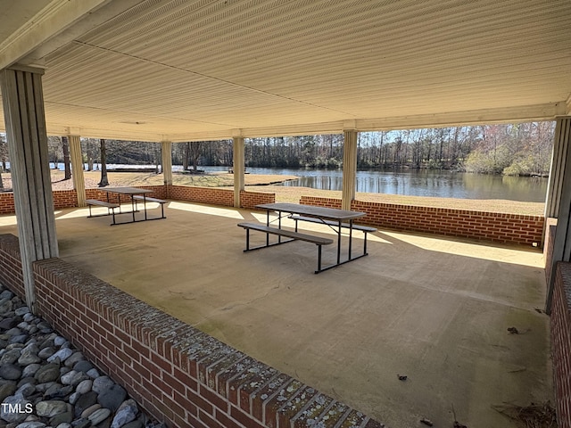 view of property's community featuring a patio area and a water view