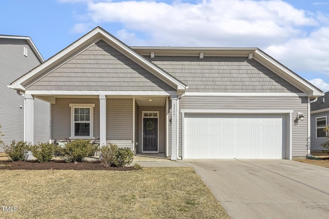 view of front of house featuring a garage, a porch, and concrete driveway