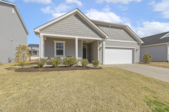 view of front of house featuring a porch, a front lawn, driveway, and an attached garage