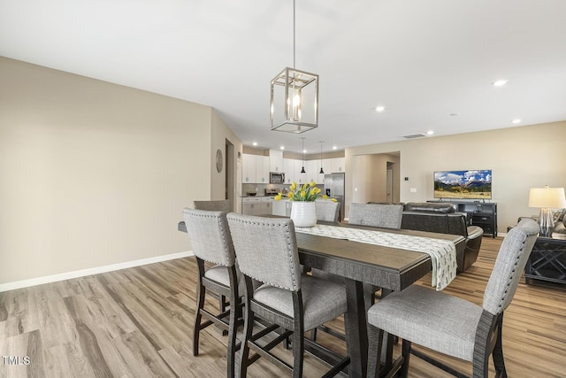 dining area featuring light wood-type flooring, visible vents, baseboards, and recessed lighting