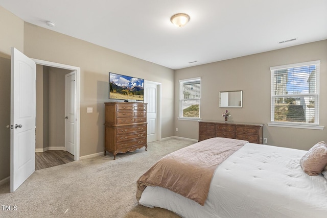 carpeted bedroom featuring visible vents and baseboards