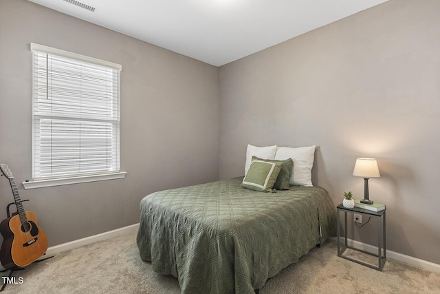 carpeted bedroom featuring visible vents and baseboards