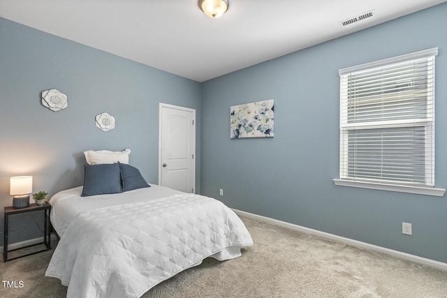 carpeted bedroom with visible vents and baseboards