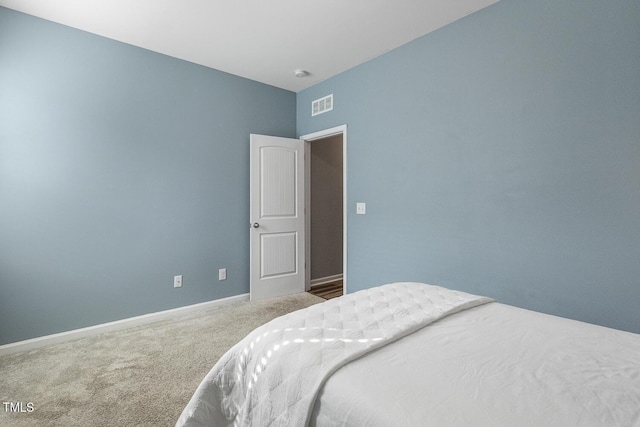 carpeted bedroom featuring baseboards and visible vents