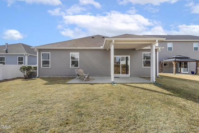 rear view of house featuring a patio area, fence, a gazebo, and a lawn