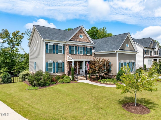 view of front of house featuring a front lawn and fence