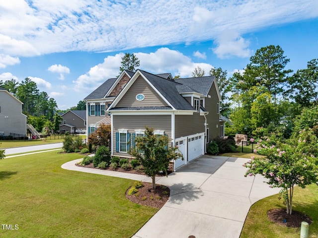 craftsman-style home with an attached garage, driveway, a front yard, and fence