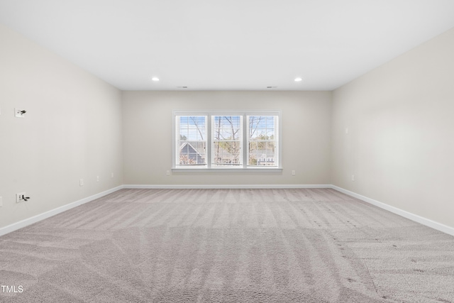 spare room with light carpet, baseboards, and recessed lighting