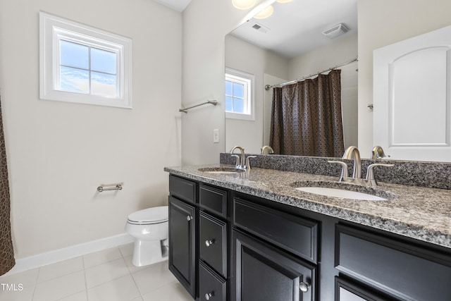 full bath featuring double vanity, a sink, visible vents, and tile patterned floors