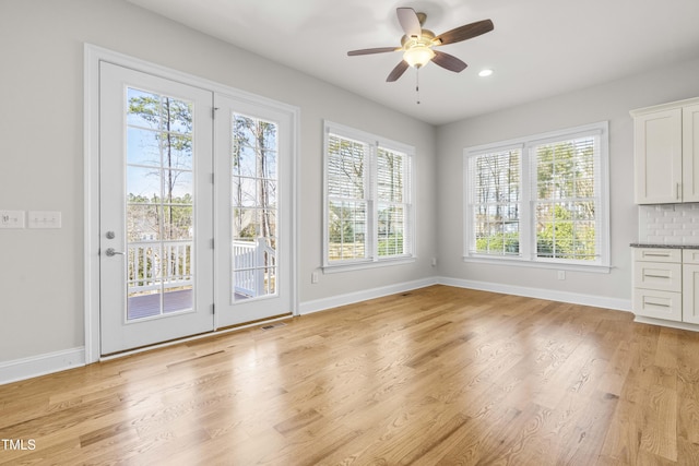 doorway featuring visible vents, light wood-style flooring, and baseboards