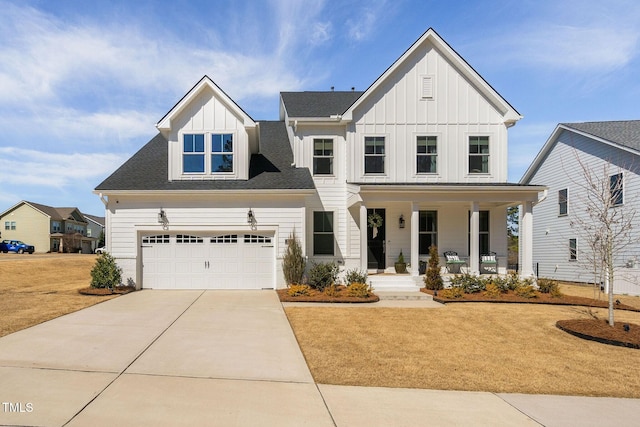 modern farmhouse style home featuring a garage, board and batten siding, a porch, and concrete driveway