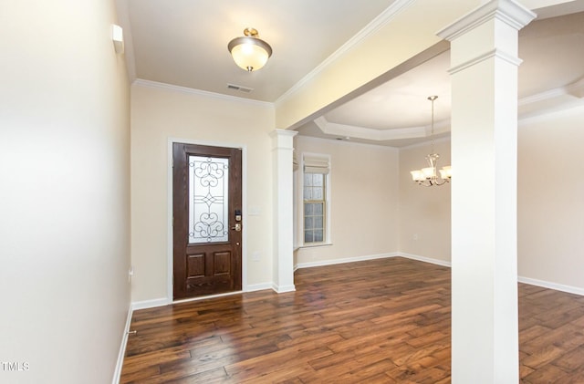 foyer entrance featuring hardwood / wood-style flooring, decorative columns, visible vents, and ornamental molding