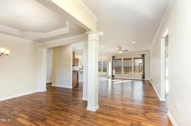 interior space with ceiling fan with notable chandelier, dark wood-style flooring, decorative columns, and baseboards