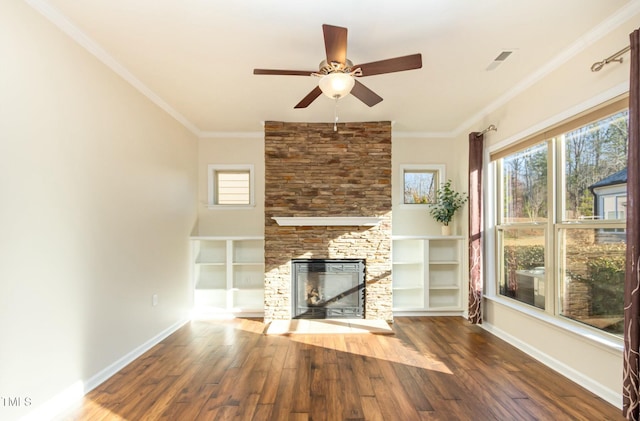 unfurnished living room featuring ornamental molding, a fireplace, baseboards, and wood finished floors