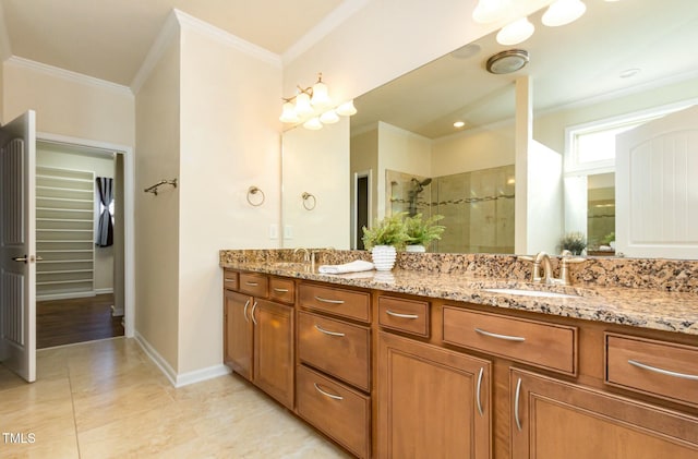 full bath featuring double vanity, a stall shower, a sink, and crown molding