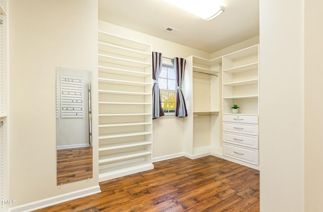 walk in closet featuring dark wood-style flooring and visible vents