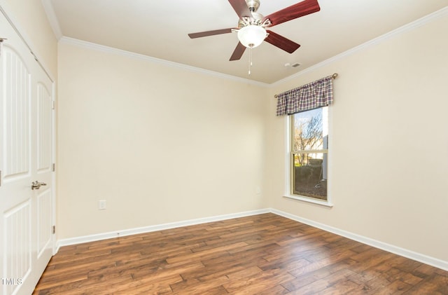 spare room featuring ceiling fan, baseboards, hardwood / wood-style floors, and ornamental molding