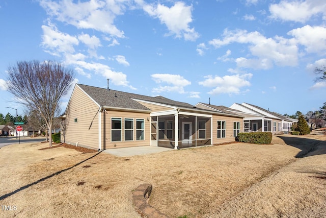 rear view of property featuring a sunroom