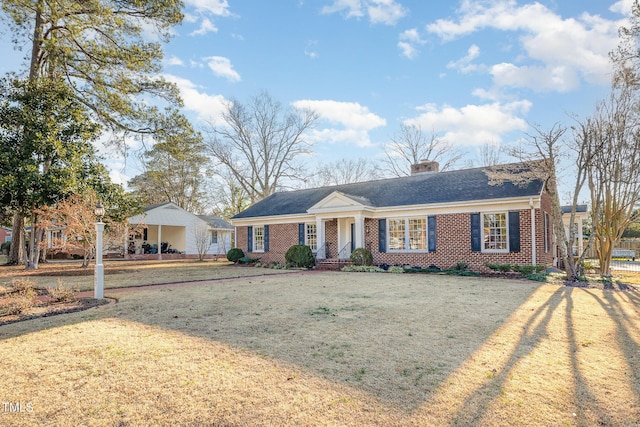 ranch-style home featuring a front yard