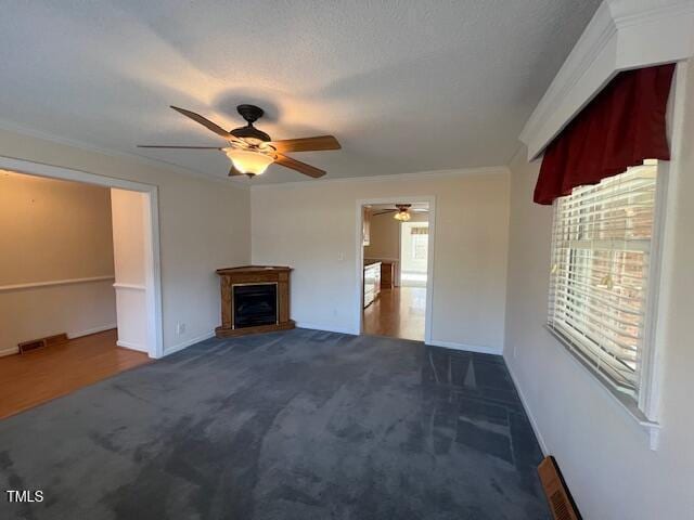 unfurnished living room featuring ornamental molding, carpet, and a wealth of natural light