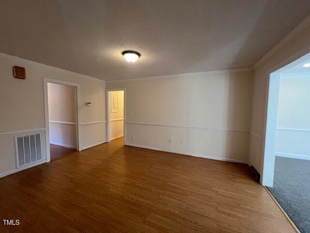 unfurnished room featuring crown molding and dark hardwood / wood-style flooring