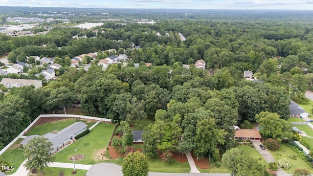 bird's eye view featuring a wooded view and a residential view