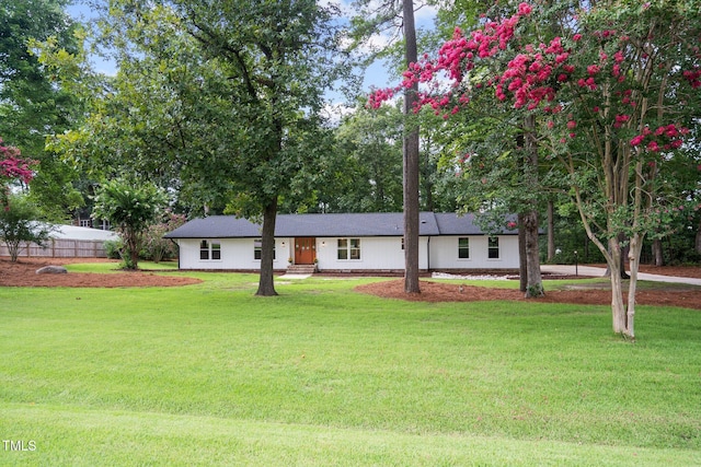 single story home featuring a front yard and fence