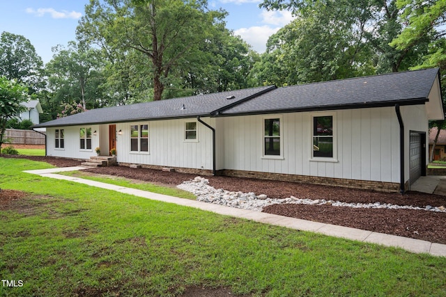 ranch-style house with a front lawn and roof with shingles