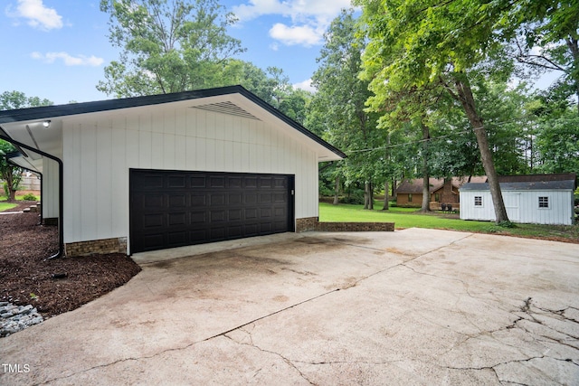 garage featuring concrete driveway