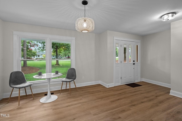 foyer with light wood-style flooring and baseboards