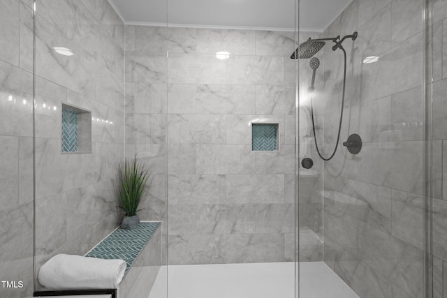 full bathroom with ornamental molding and tiled shower