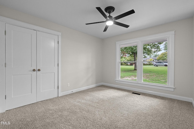 unfurnished bedroom with a closet, carpet flooring, visible vents, and baseboards