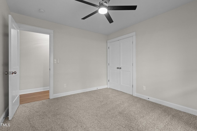 unfurnished bedroom featuring a ceiling fan, a closet, baseboards, and carpet flooring