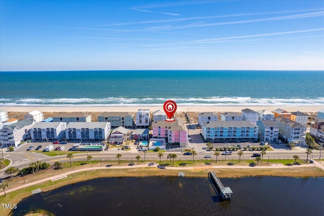 birds eye view of property featuring a water view and a view of the beach