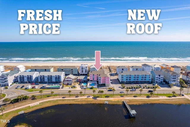 drone / aerial view featuring a water view and a beach view