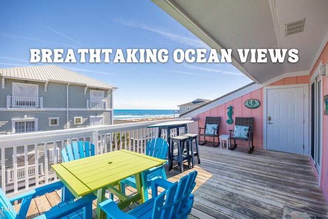 wooden deck with a beach view, visible vents, and a water view