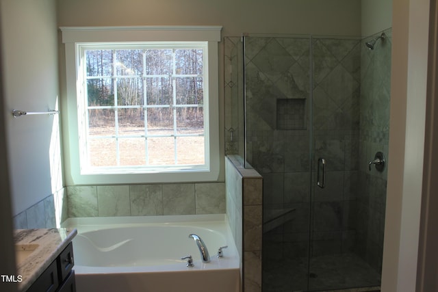 bathroom with shower with separate bathtub and vanity