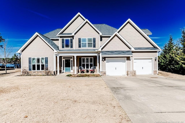 craftsman-style house featuring a garage and covered porch