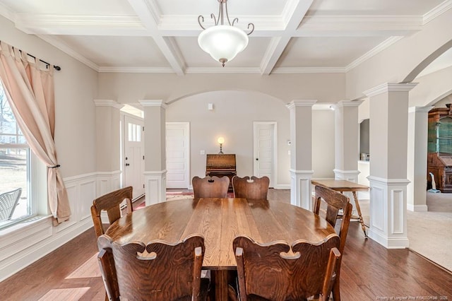 dining space with beamed ceiling, coffered ceiling, and decorative columns