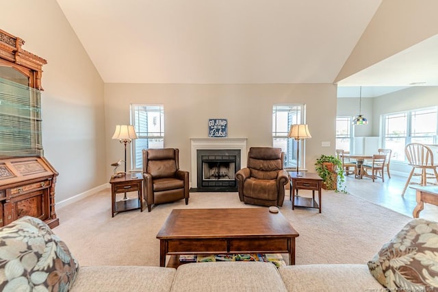 carpeted living room featuring high vaulted ceiling