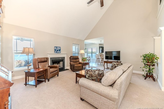 living room featuring ceiling fan, light carpet, and high vaulted ceiling