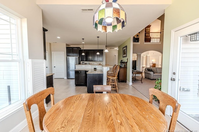 dining space featuring decorative columns