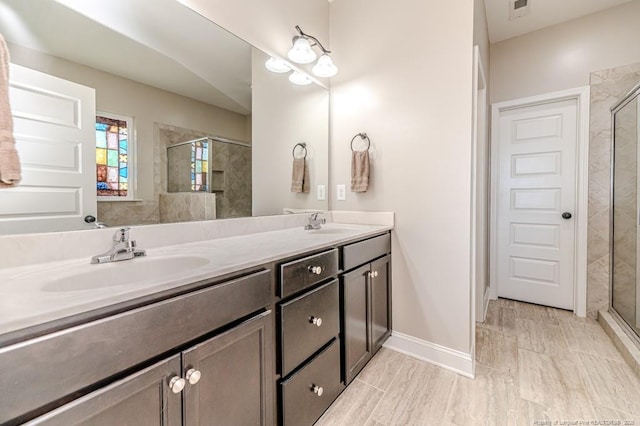 bathroom featuring vanity and a shower with door