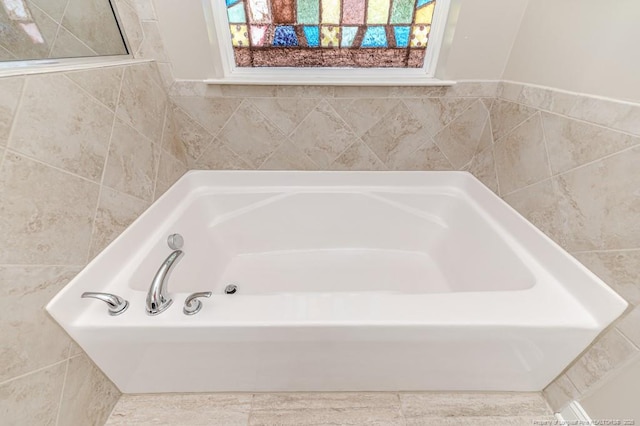 bathroom with plenty of natural light and a bathing tub